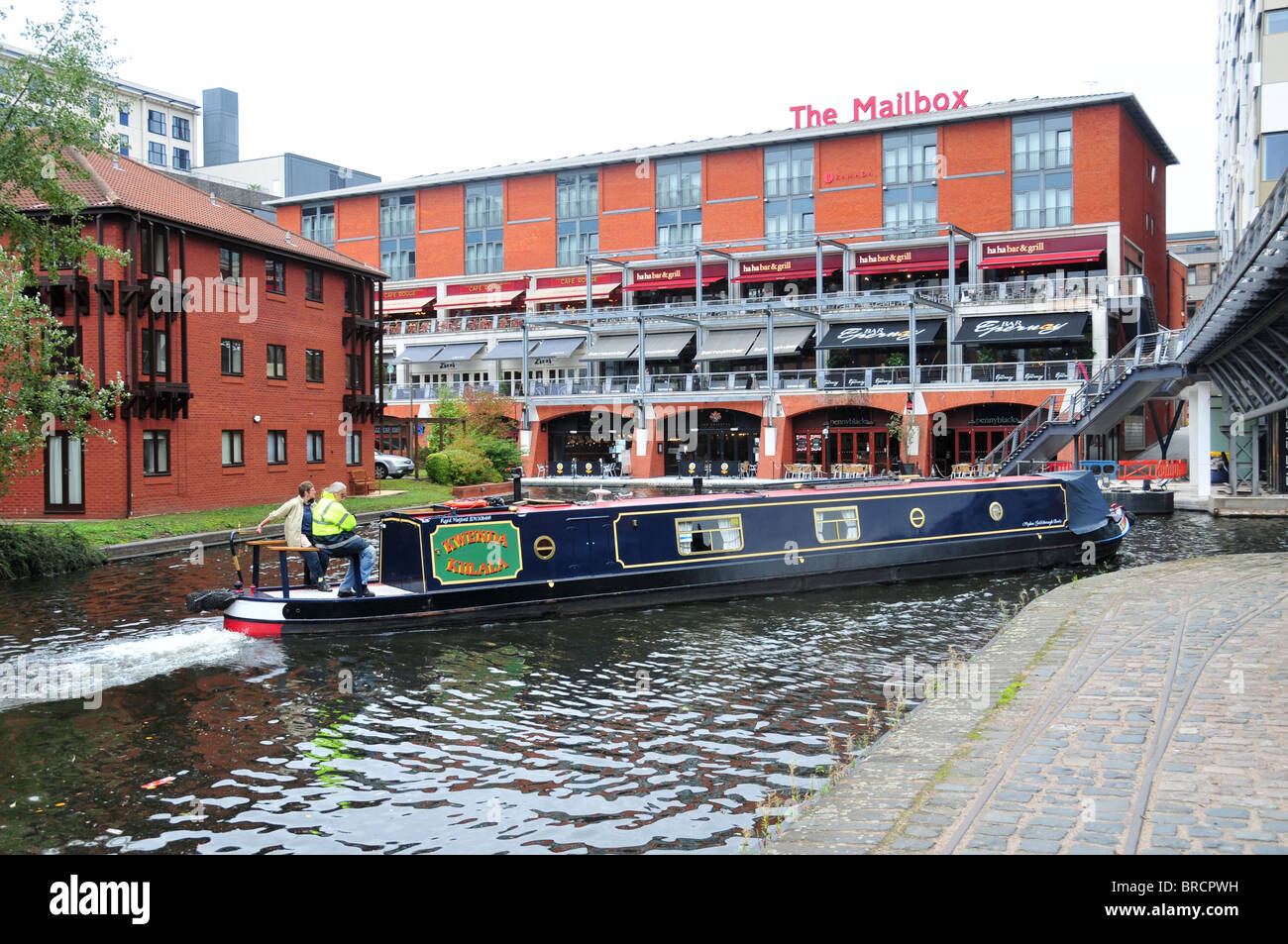 Narrowboat on Birmingham Canal passing to rear of The Mailbox Centre Stock Photo