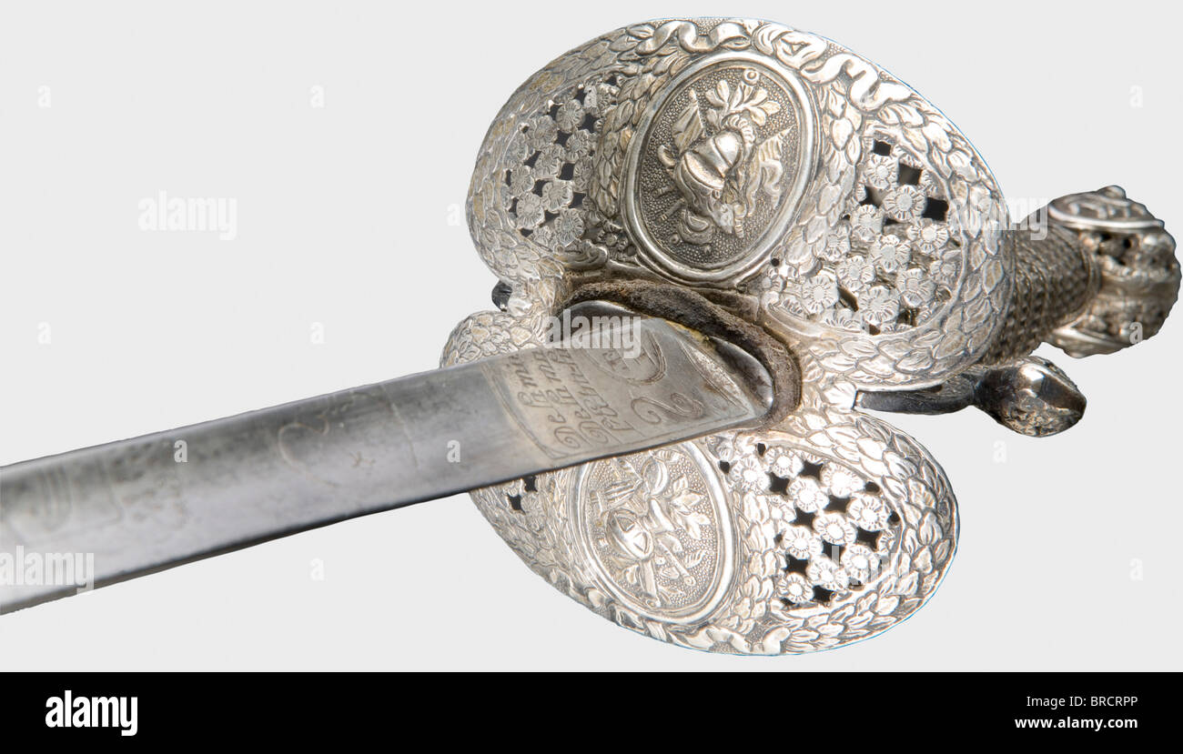 A French silver-hilted small-sword, circa 1780 A triangular thrusting blade etched with cabalistic characters, bust of a hussars, crescent moon, star and the maker's inscription, 'Lepeton' from Rouen. Silver, flower-shaped openwork knuckle-bow hilt in relief with original lavish silver wire grip winding and Turk's heads. Length 99.5 cm. historic, historical, 18th century, dress sword, swords, thrusting, thrustings, smallsword, epee de cour, weapon, arms, weapons, arms, military, militaria, object, objects, stills, clipping, clippings, cut out, cut-out, cut-outs, Stock Photo
