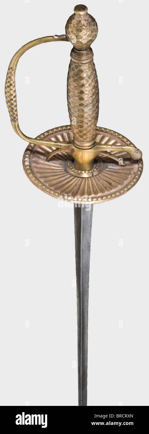 A French small-sword, circa 1790 A smooth triangular thrusting blade with a brass hilt bearing remnants of gilding. The interior of the guard plate is decorated with radiating flutes. The knuckle-bow, grip, and pommel chased in a lozenge pattern. Length 95.5 cm. historic, historical, 18th century, dress sword, swords, thrusting, thrustings, smallsword, epee de cour, weapon, arms, weapons, arms, military, militaria, object, objects, stills, clipping, clippings, cut out, cut-out, cut-outs, Stock Photo