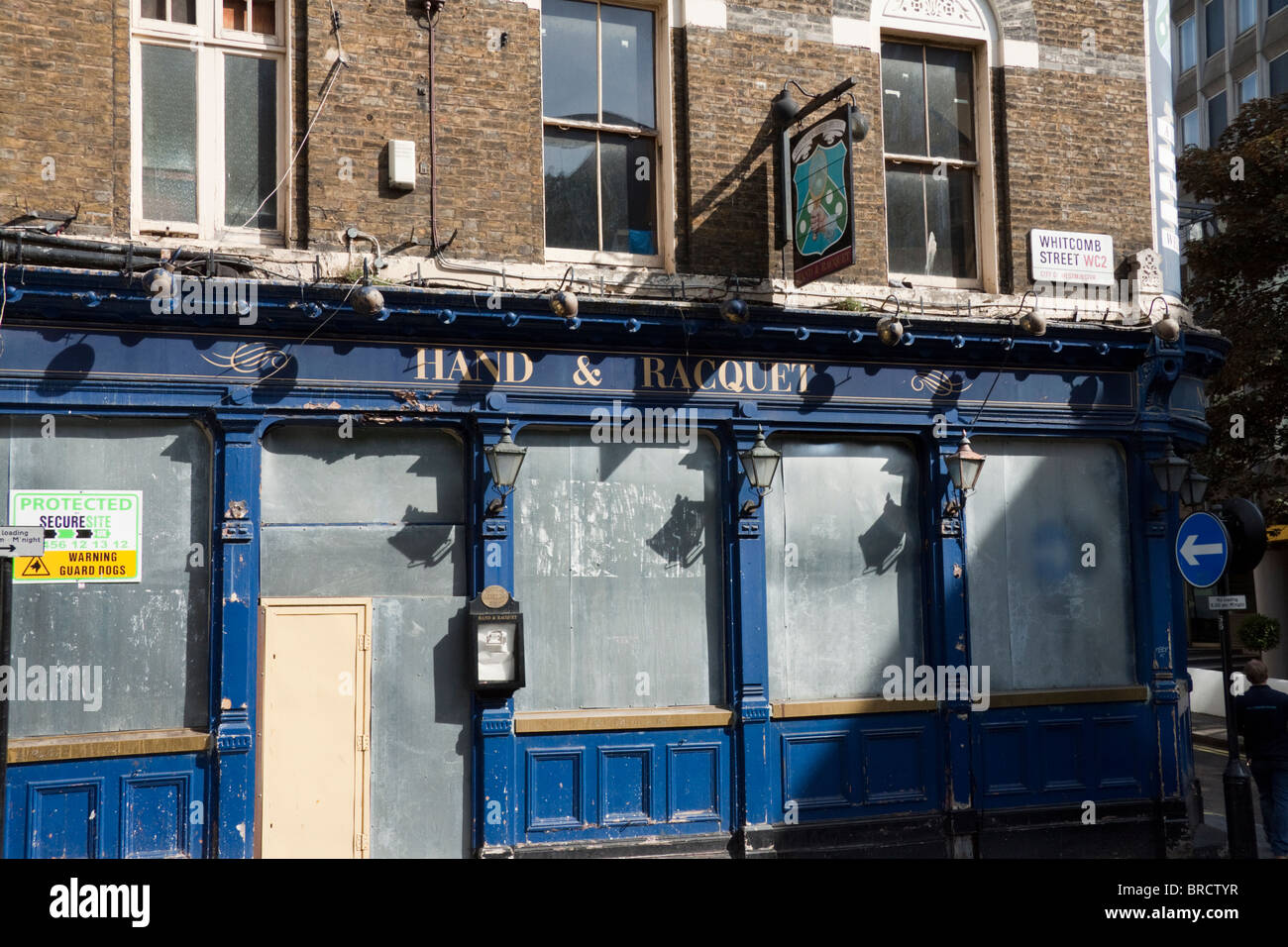 Derelict pub, Hand & Racquet, with boarded up windows in Londons West End, England, UK Stock Photo