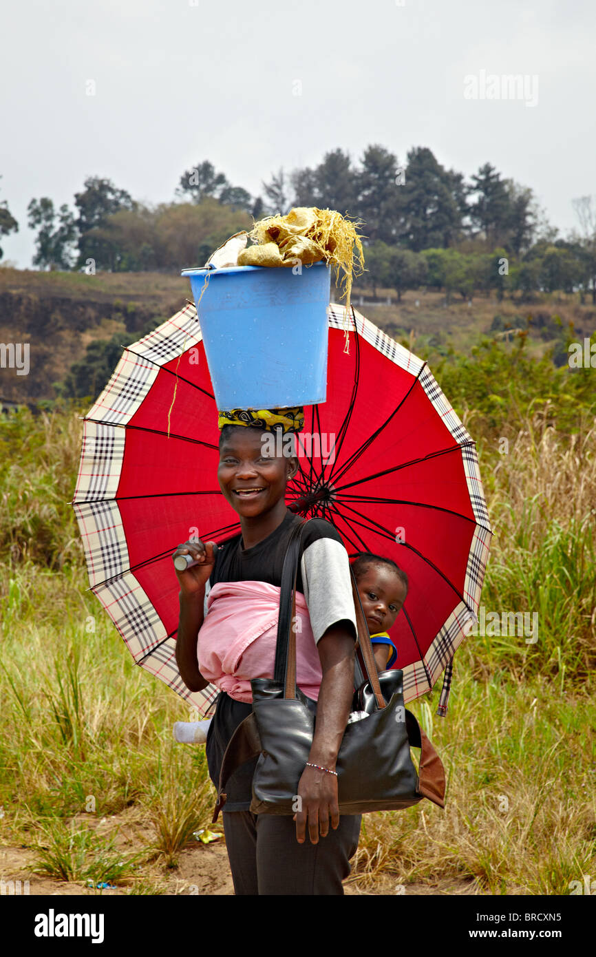 Congolese girl woman with a baby on her back, Brazzaville, Republic of Congo, Africa Stock Photo