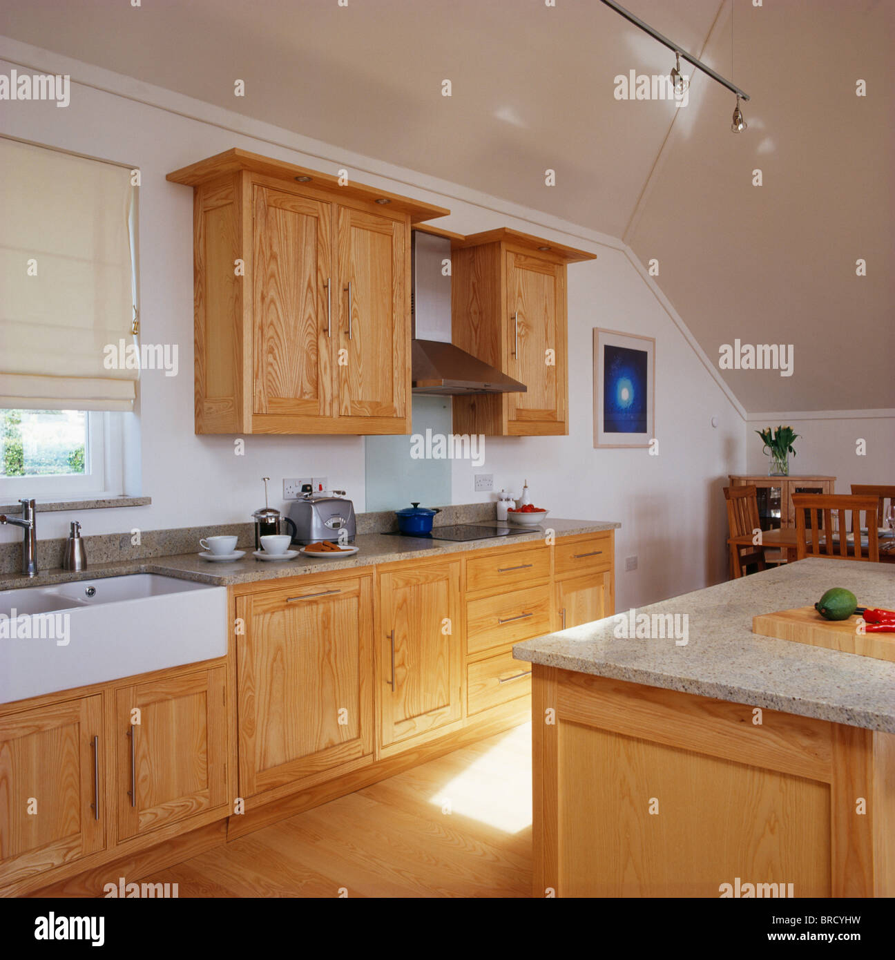 Pale wood fitted units in modern white kitchen Stock Photo - Alamy