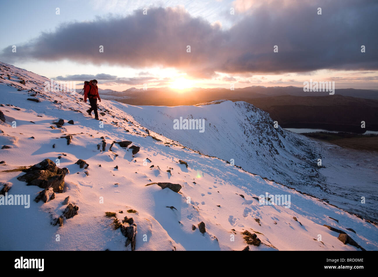 Descending from Helvellyn in winter at sunset. Lake District National Park, England. Stock Photo