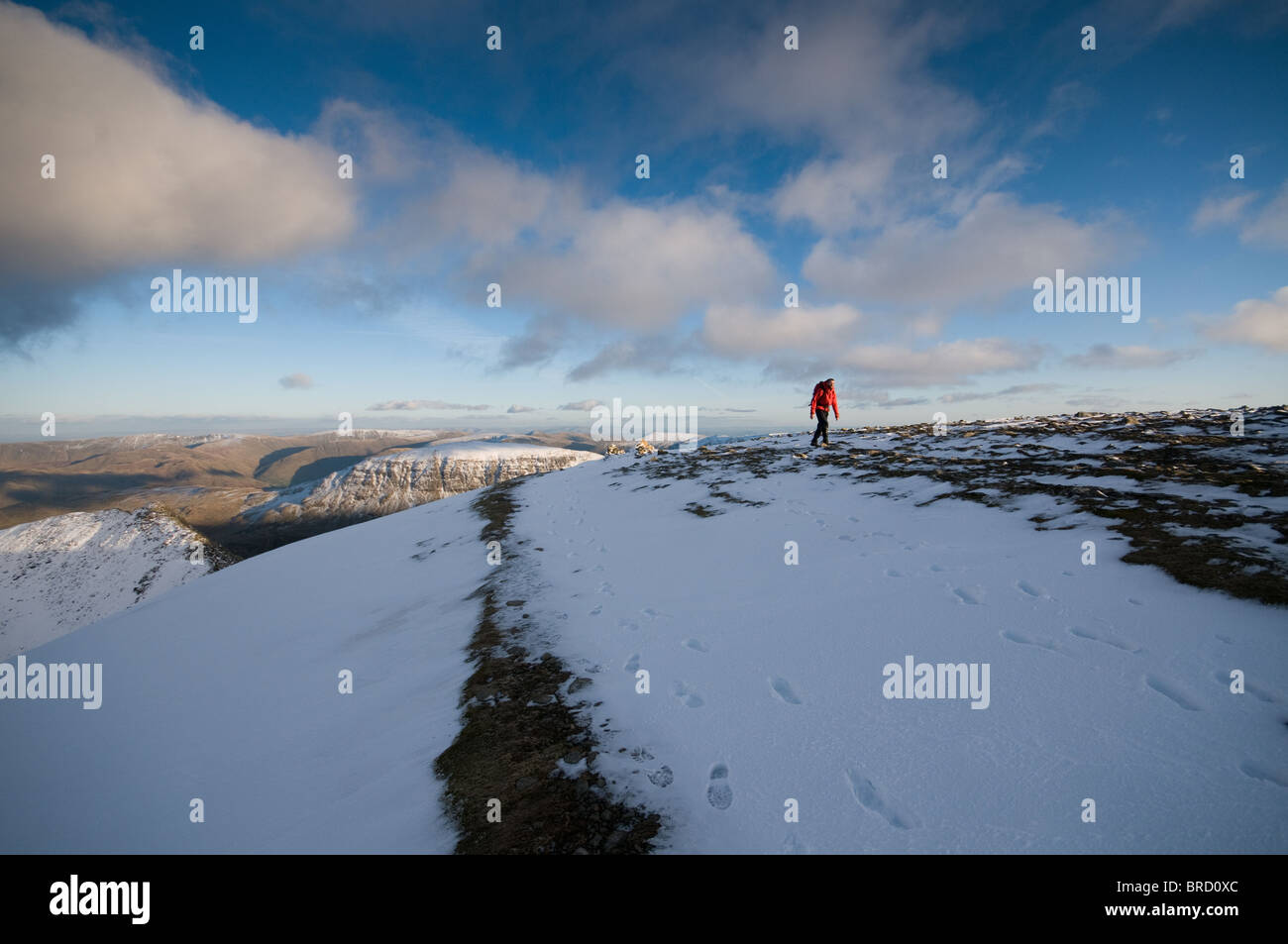 Solitary winter walking on the summit of Helvellyn in the Lake District National Park, England. Stock Photo