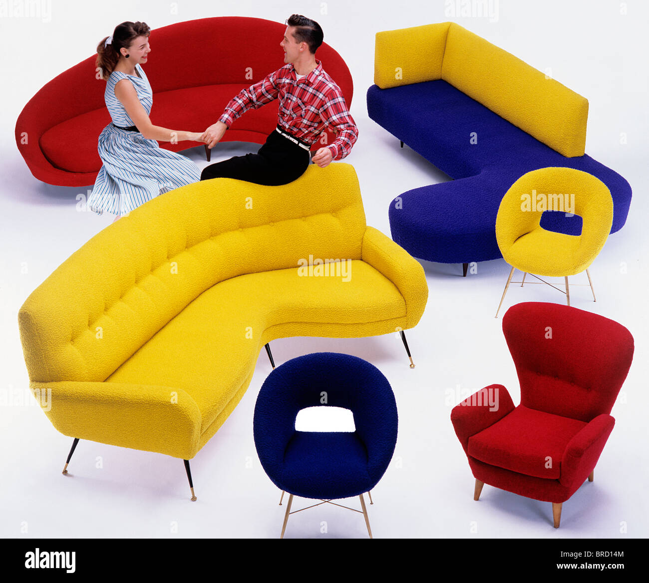Fifties Furniture, sofas and chairs with jiving/fifties models Stock Photo