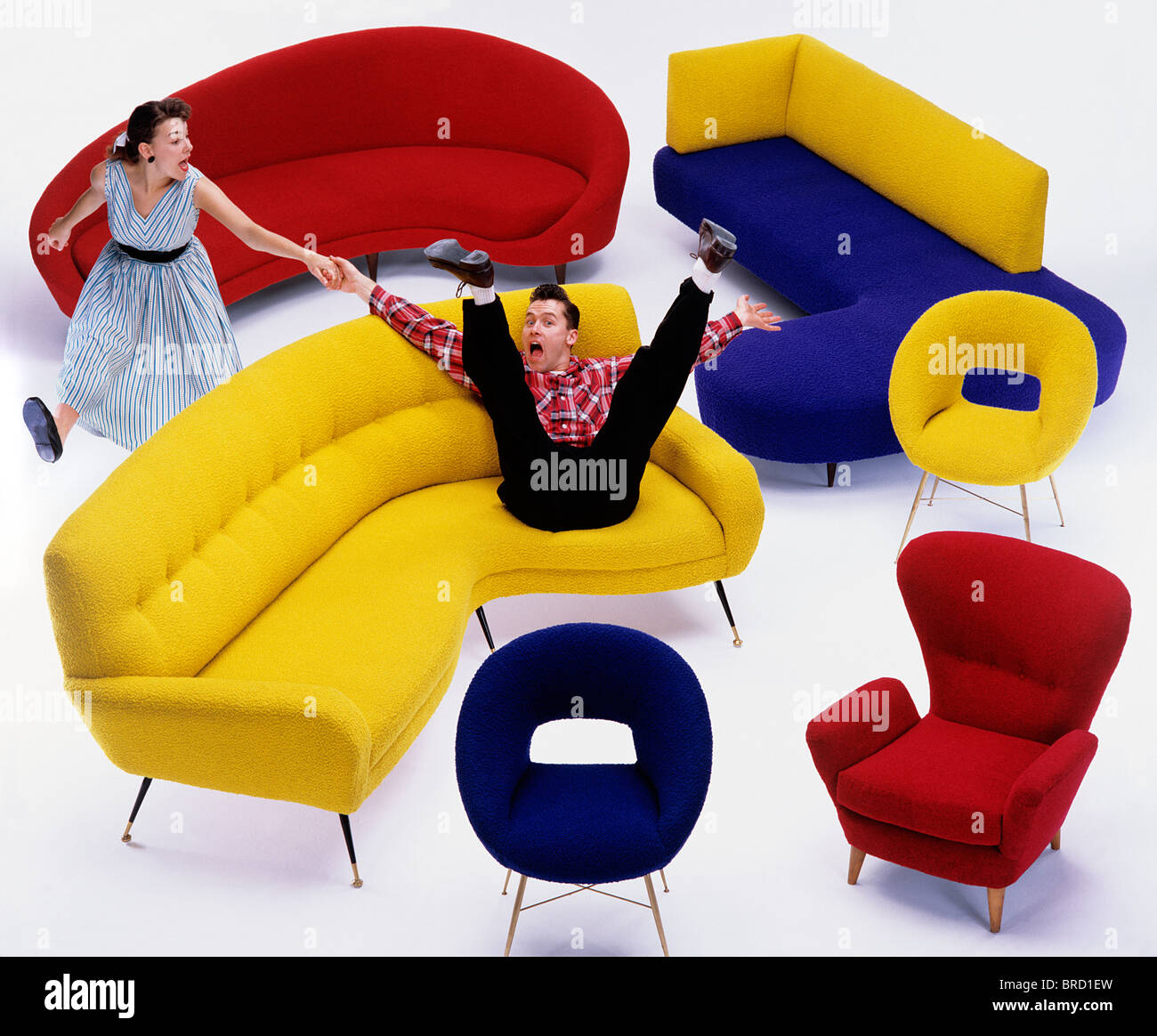 Fifties Furniture, sofas and chairs with jiving/fifties models Stock Photo