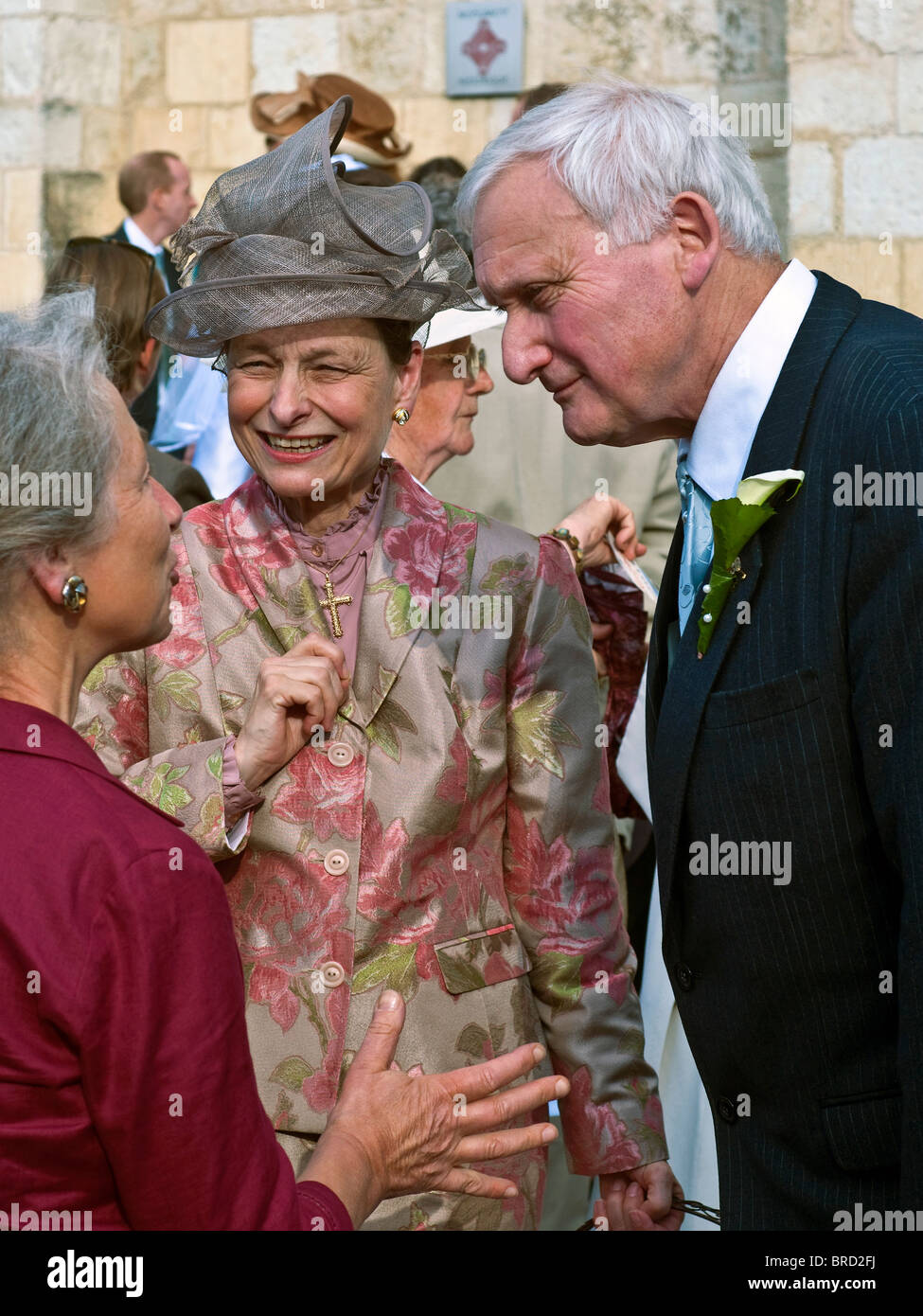 Older wedding guests talking outside church after wedding - France ...