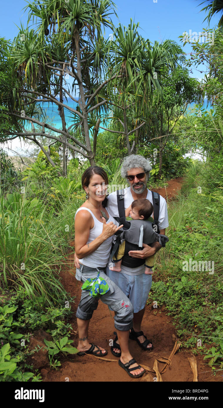 Couple with baby hiking the Kalalau Trail on Kauai Stock Photo