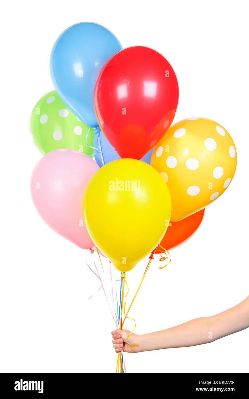 Hand holding colorful helium balloons isolated on white background ...