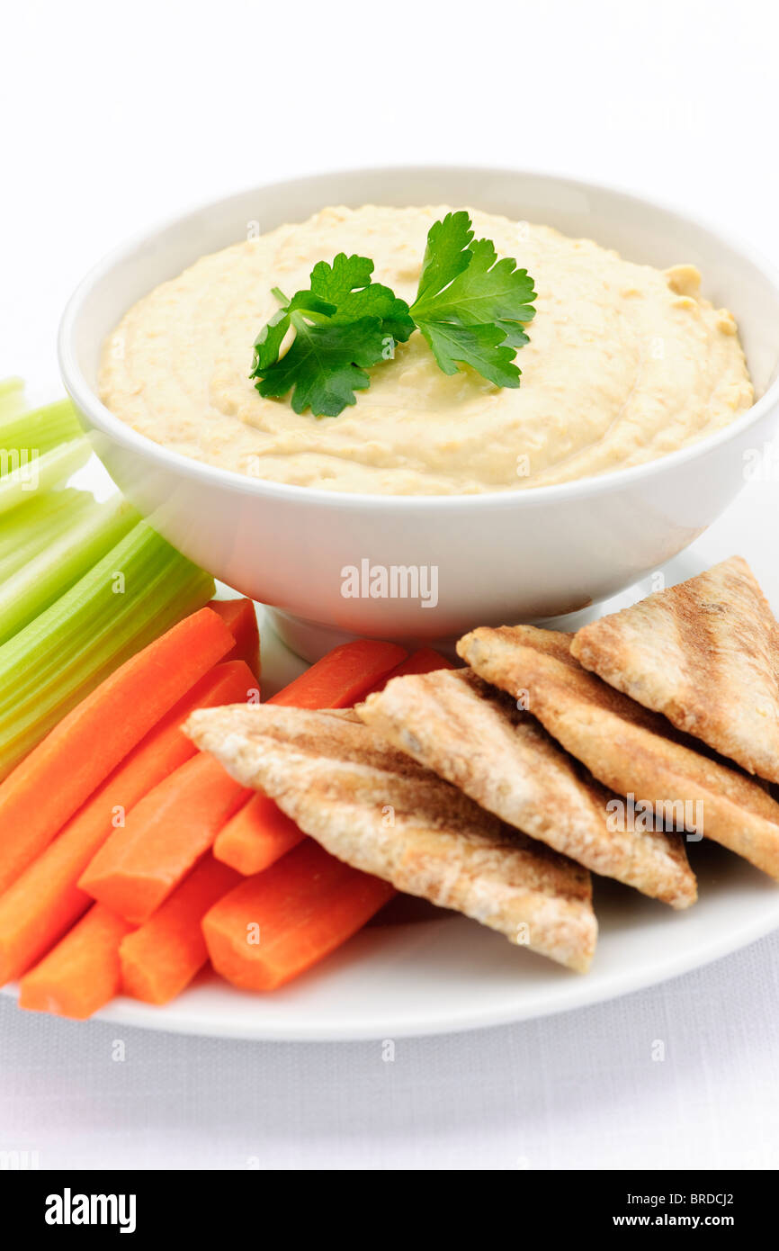 Healthy snack of hummus dip with pita bread slices and vegetables Stock Photo