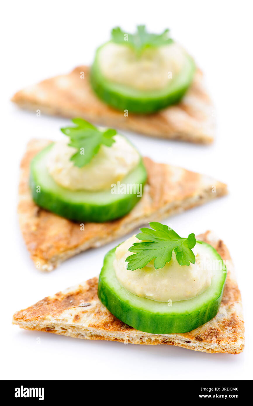 Appetizer of hummus and cucumber slices on pita bread Stock Photo