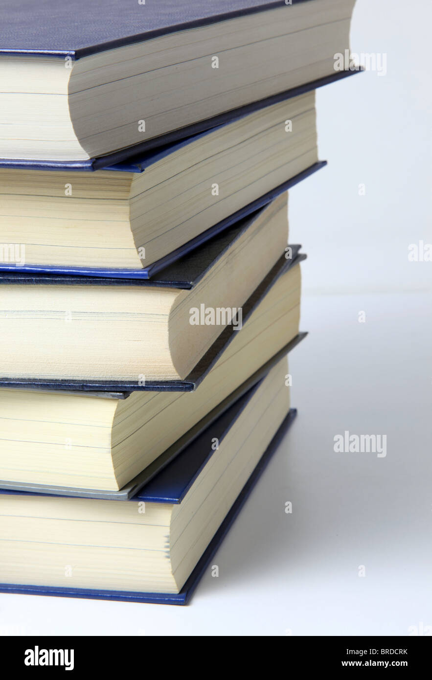 Several books lying one upon another. All on white background. Stock Photo