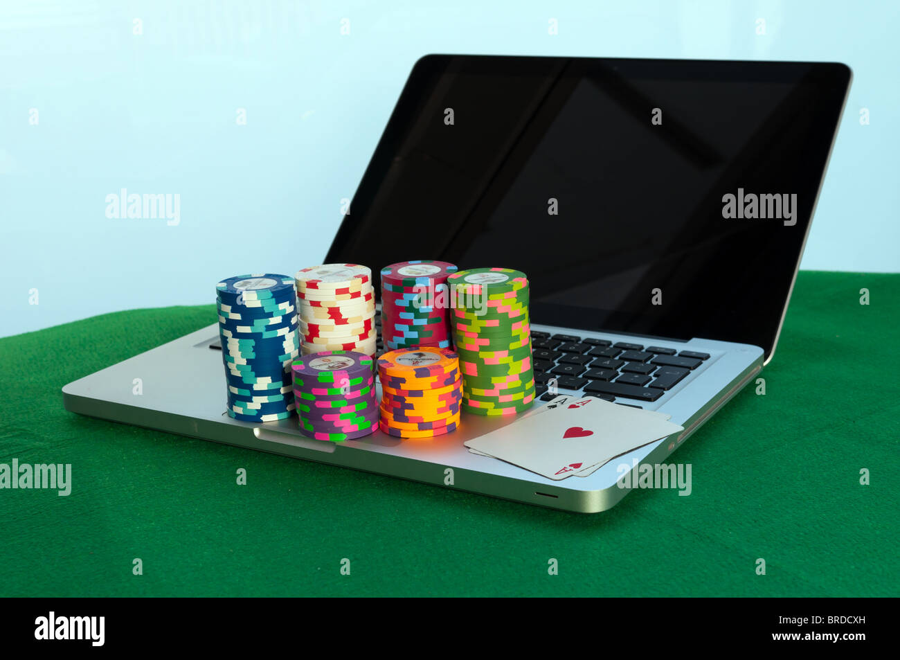 Poker chips and a laptop computer Stock Photo