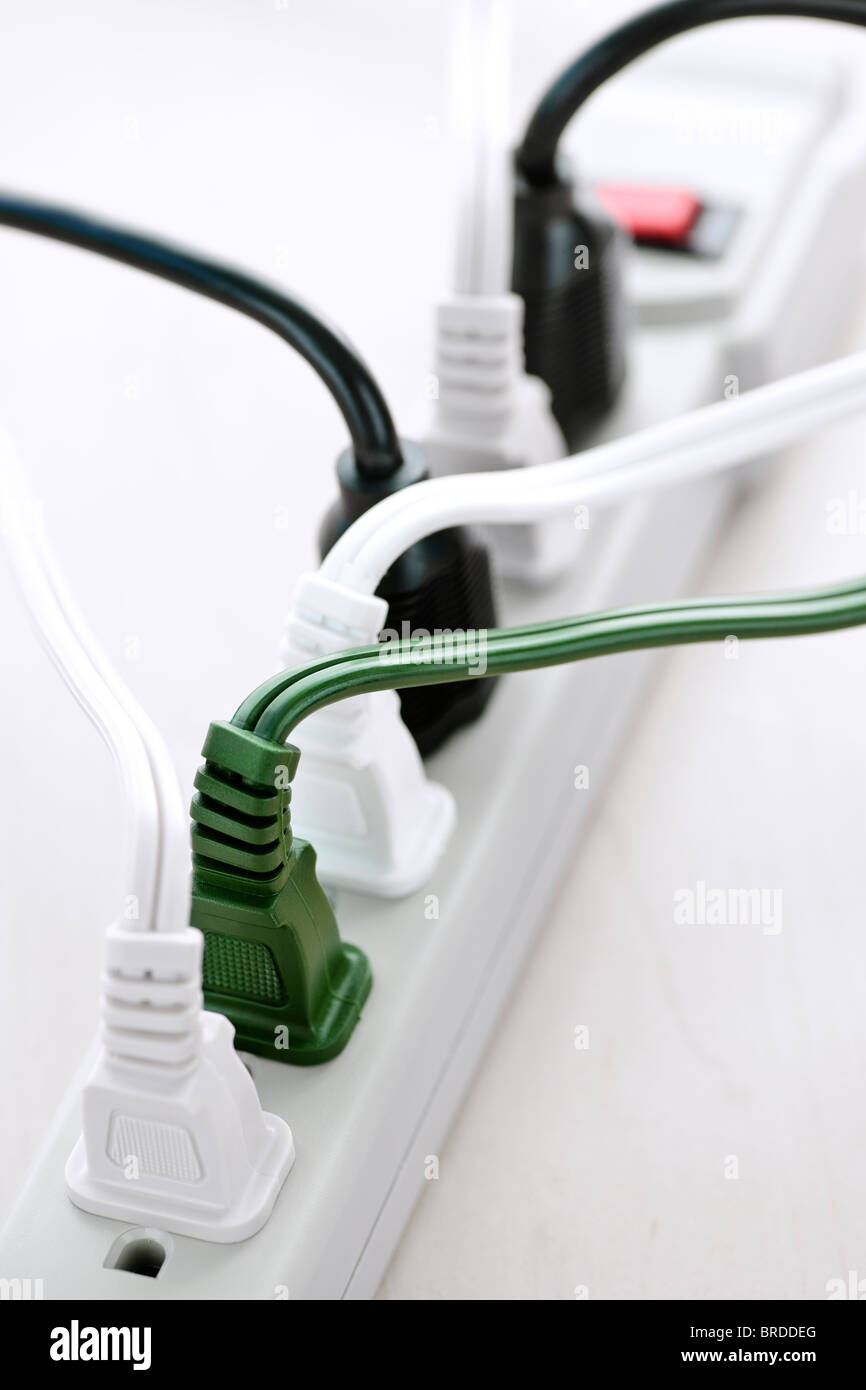 Many plugs plugged into electric power bar Stock Photo Alamy