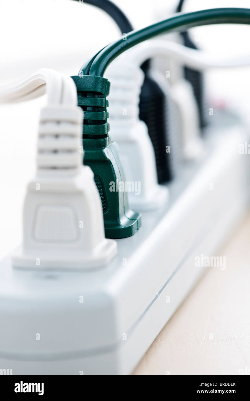 Many plugs plugged into electric power bar Stock Photo Alamy