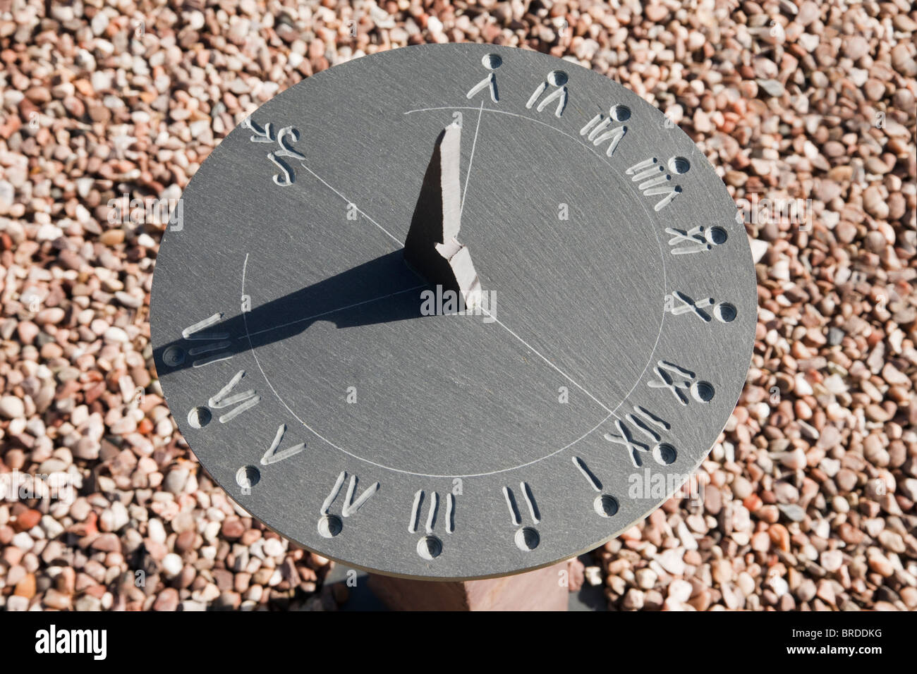 Close up of a garden sundial made from slate at 7pm in the evening. UK, Britain. Stock Photo