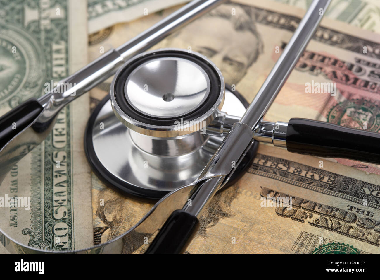 medical stethoscope on a pile of us dollar banknotes Stock Photo