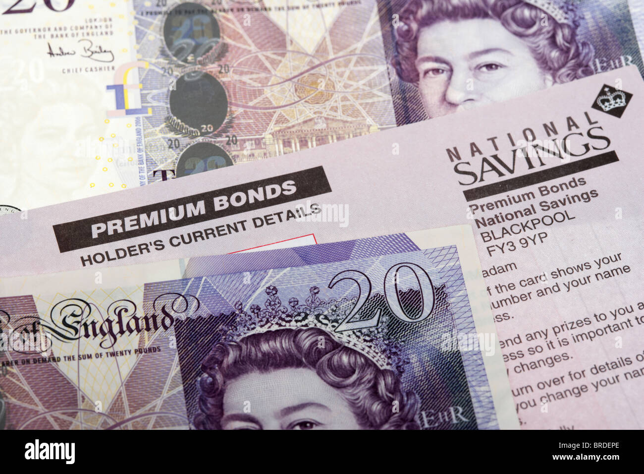 premium bonds holder cards with twenty pound notes in the uk Stock Photo