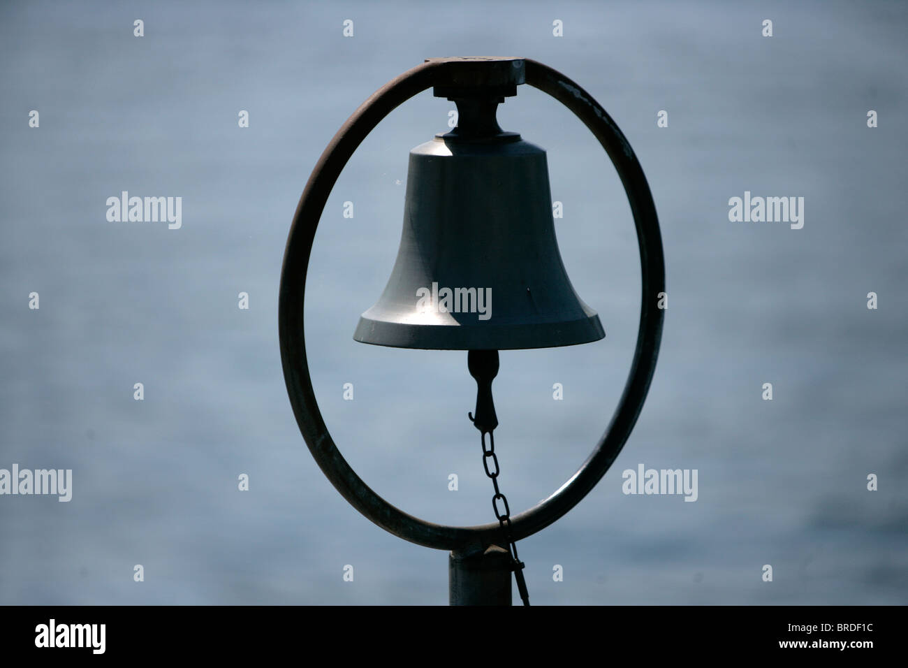 A Ship's Bell stands by the side of Lake Zurich in Kusnacht, Switzerland. Stock Photo