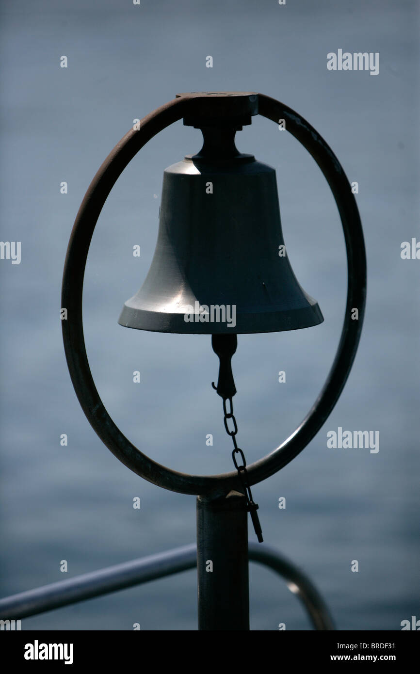 A Ship's Bell stands by the side of Lake Zurich in Kusnacht, Switzerland. Stock Photo