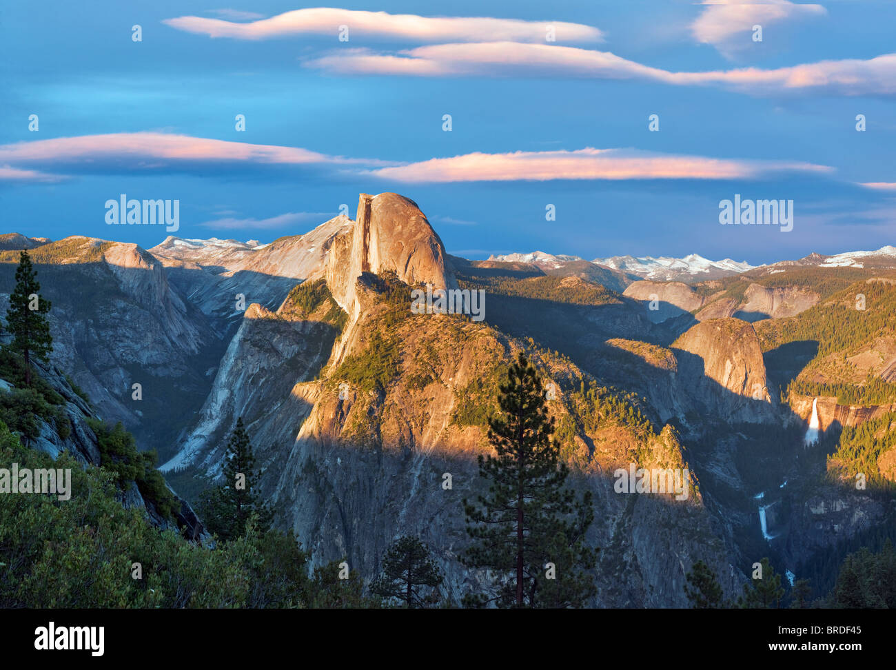 View of Half Dome and waterfalls from Glacier Point with sunset clouds. Yosemite National Park, California. Sky has been added. Stock Photo
