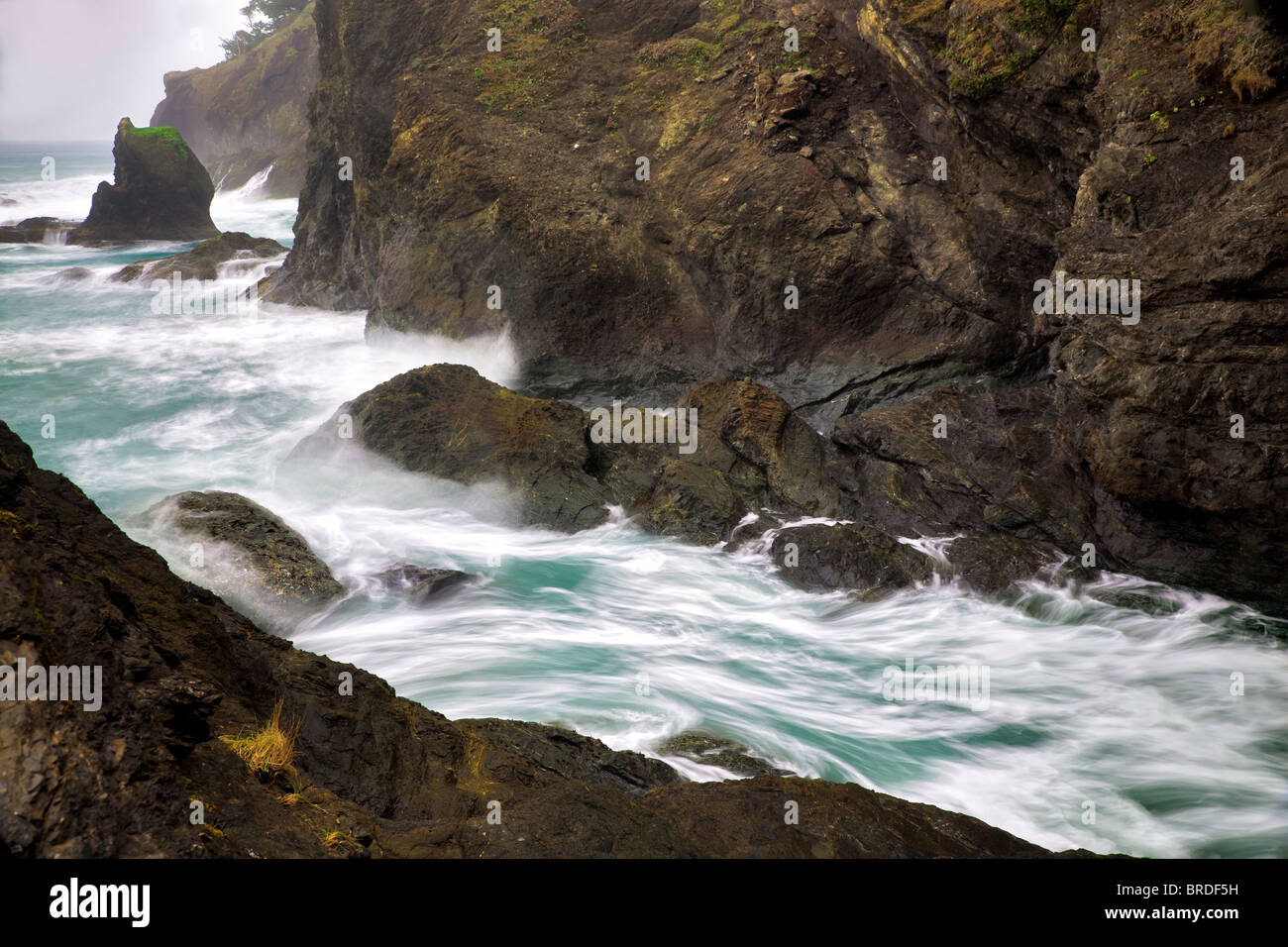 Wave action and rocky shoreline at Samuel H. Boardman State Scenic Corridor. Oregon Stock Photo
