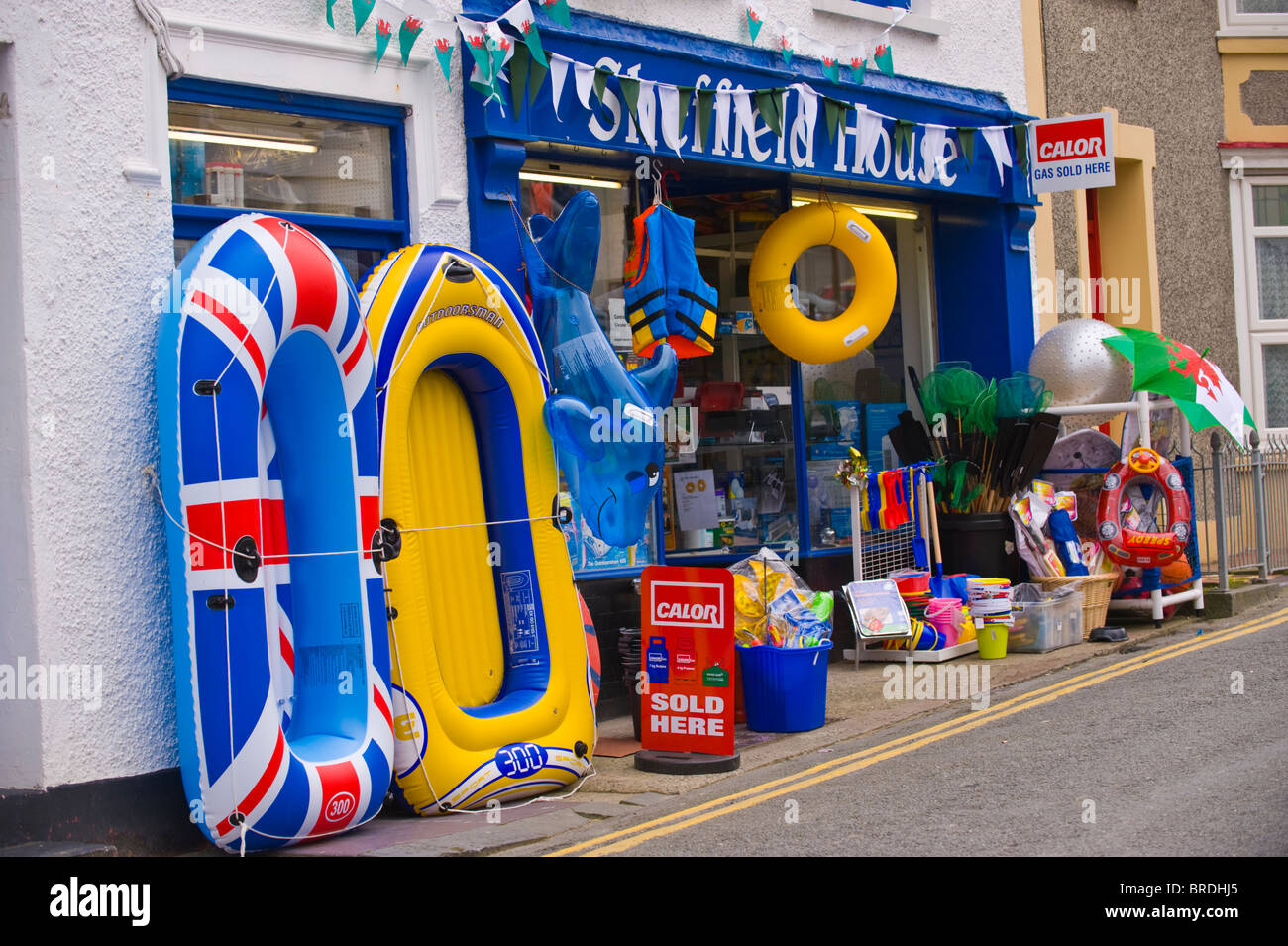 Shop selling plastic goods for holidaymakers in seaside resort of New Quay Ceredigion West Wales UK Stock Photo