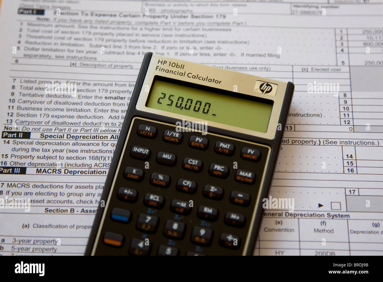 Calculator calculating income taxes on tax form, expenses and income Stock Photo