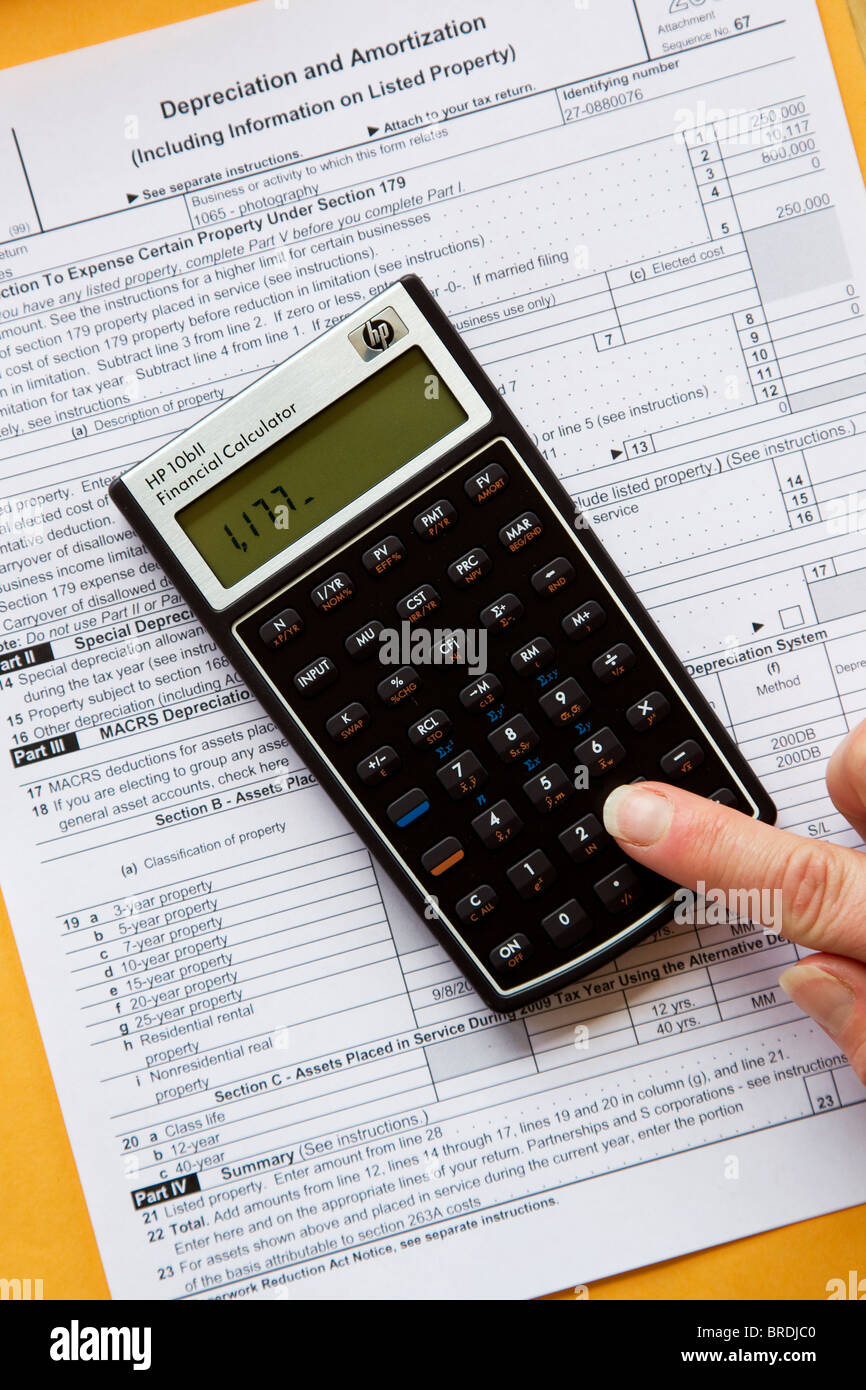 calculator calculating income taxes on tax form expenses calculating expenses