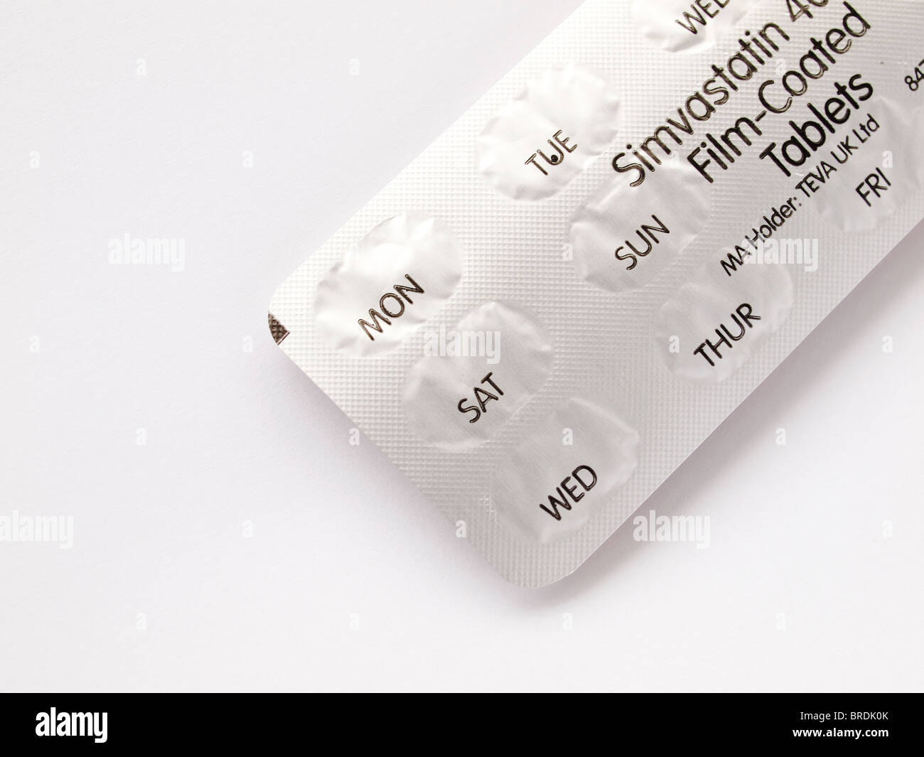 Simvastatin tablets to reduce Cholesterol by daily dose with packaging showing days as a reminder Stock Photo