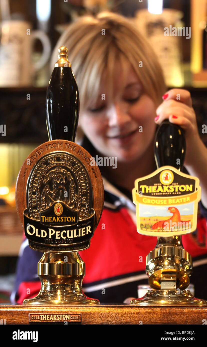 Barmaid Pulling a Pint of Theakston's Beer at their Brewery in Masham, North Yorkshire Stock Photo