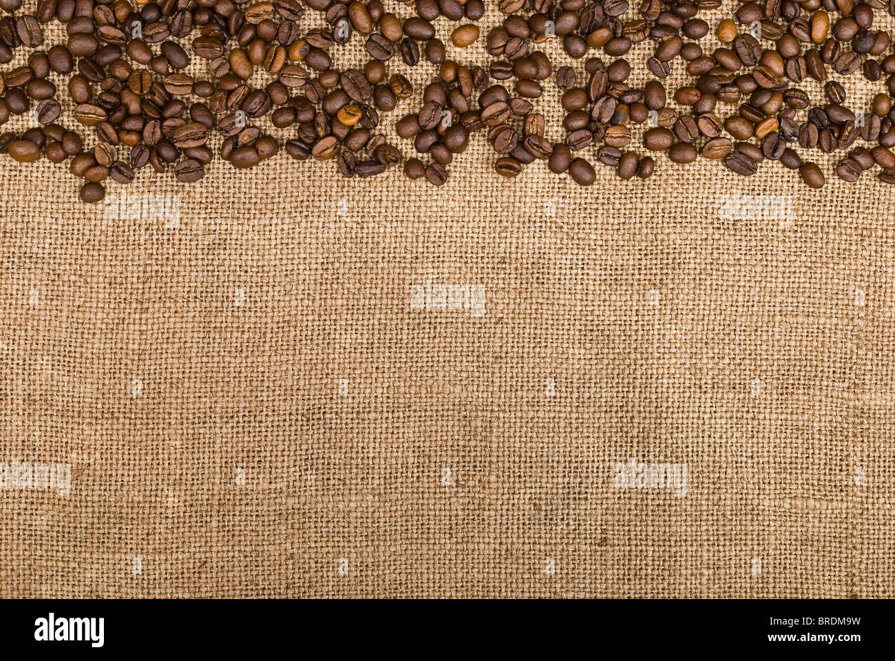 Coffee beans and sackcloth background Stock Photo