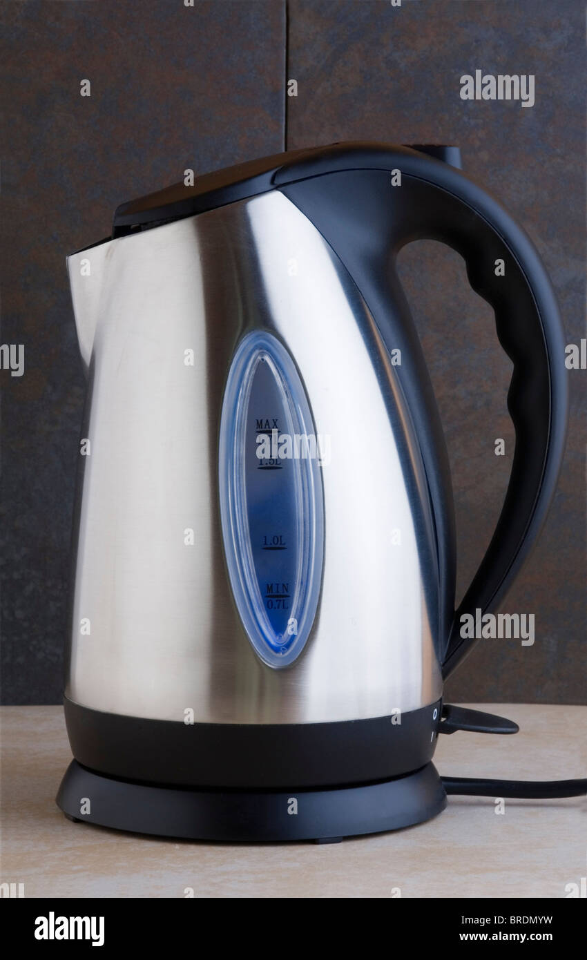 Electric kettle against a tiled background. Stock Photo