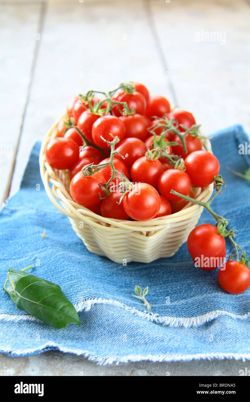 Cherry tomatoes in a wicker basket Stock Photo - Alamy