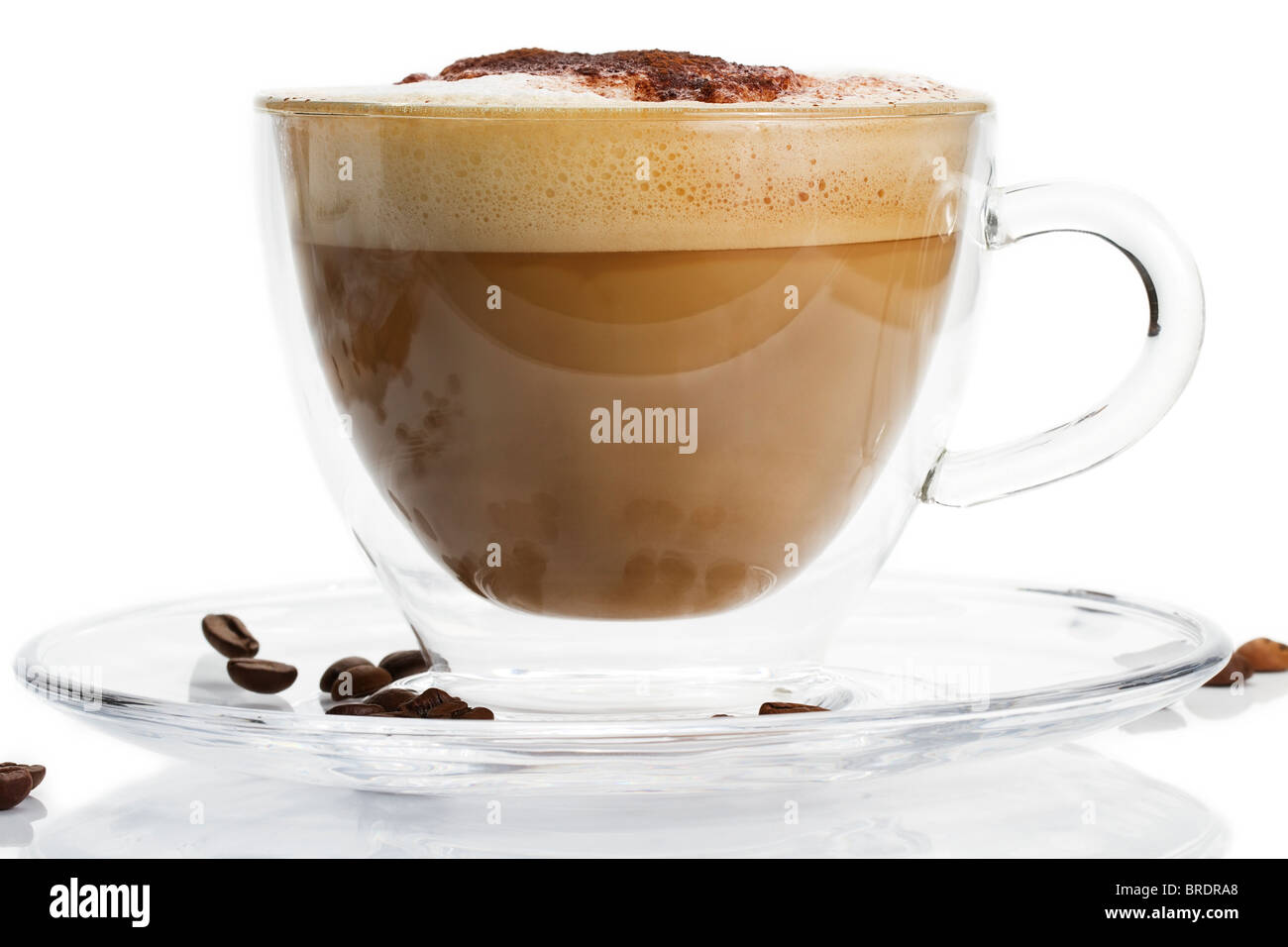cappuccino in a glass cup with chocolate powder on white background Stock Photo