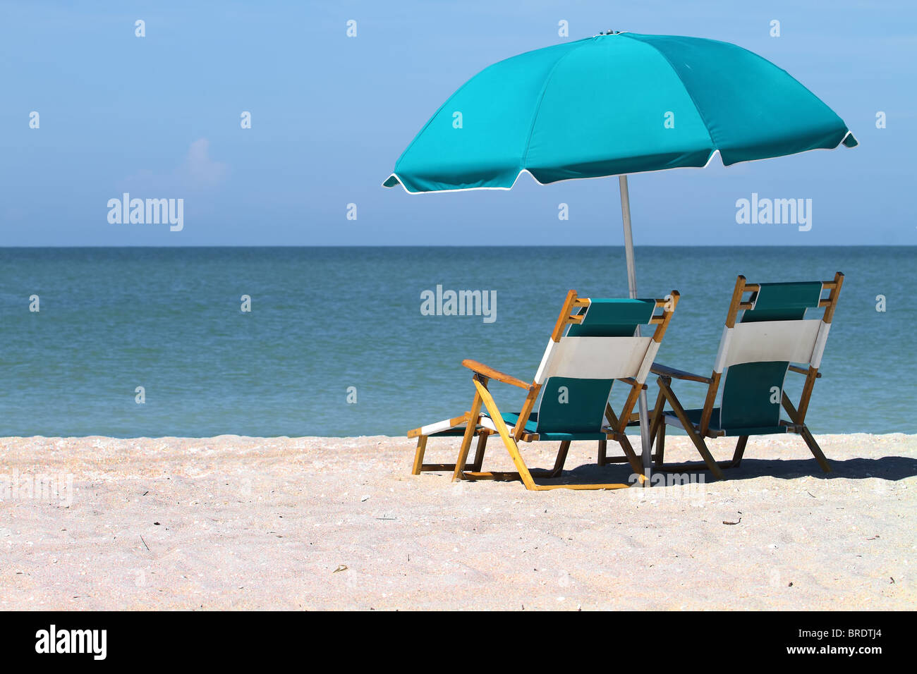 Sunshade and two chairs at beach Stock Photo