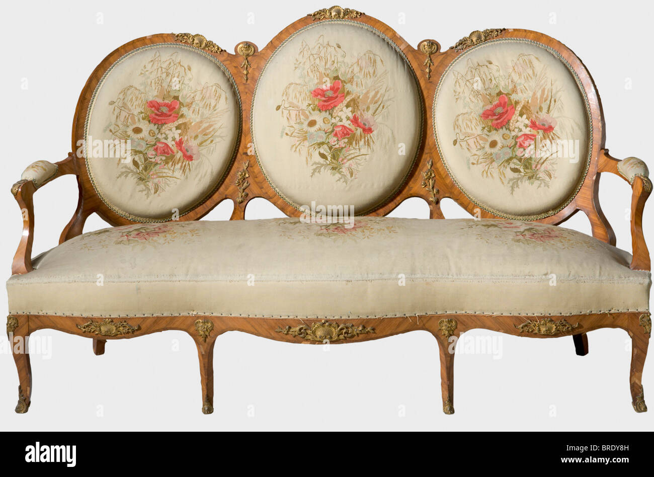 A lounge suite with rosewood veneer Gambs Workshop, Saint Petersburg, 1846, Rosewood veneer, cream-coloured brocade with flower ornaments, gilt bronze fittings, gold fringes and braids. Some losses and additions. Consisting of a three seater couch (105 x 171 x 73 cm), a two seater couch (100 x 125 x 64 cm), two recliners (96 x 61 x 55 cm), one chair (93 x 50 x 51 cm/one chair leg damaged) with two front wheels, one stool with wheels (diameter 48 cm, height 43 cm), and two matching pillows (50 x 50 cm). All pieces with several inventory labels such as 'ON' or 'O, Stock Photo