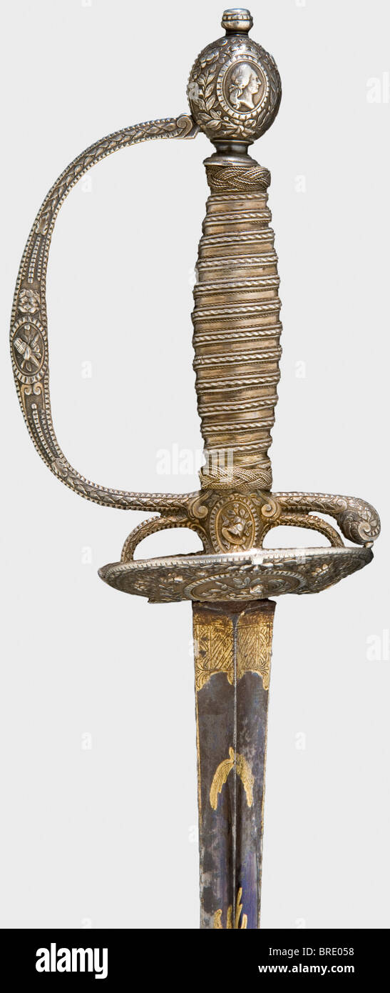 A French silver-hilted small-sword, Paris, 1775 Hollow triangular thrusting blade etched and gilt on a blued panel (mostly preserved ) on the reverse side. Silver hilt with remnants of gilding in floral relief with martial trophies within oval cartouches, each beneath a royal crown. Double shell-guard with the reverse cipher 'L' on the outside, and three fleur-de-lys within an oval coat-of-arms on the inside. The arms of the hilt is stamped with an 'M' beneath a crown, for Paris 1775. A of Louis XVI on one side of the pommel. Original silver wire boung grip wit, Stock Photo