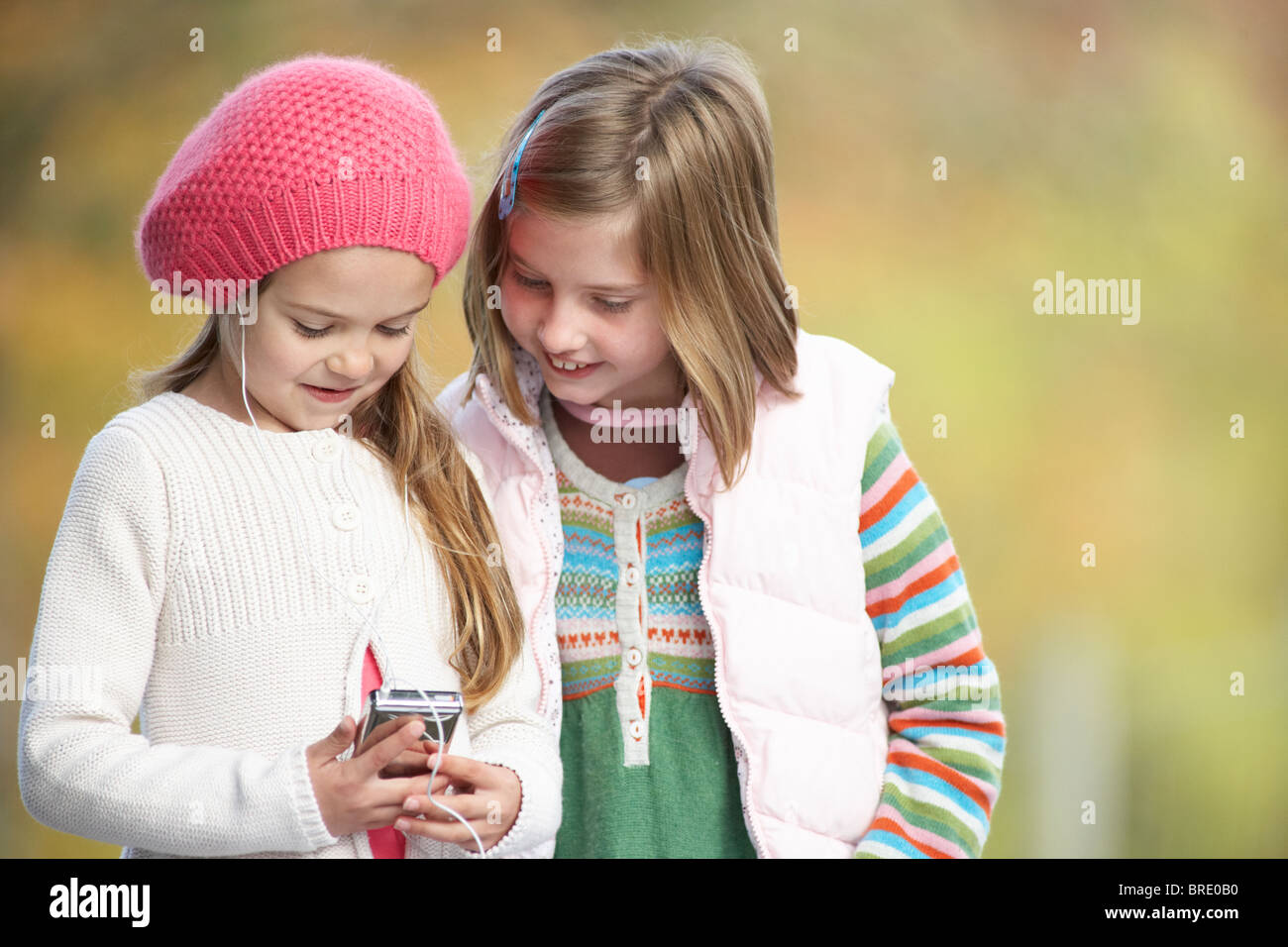 Two Young Girl Outdoors With MP3 Player Stock Photo