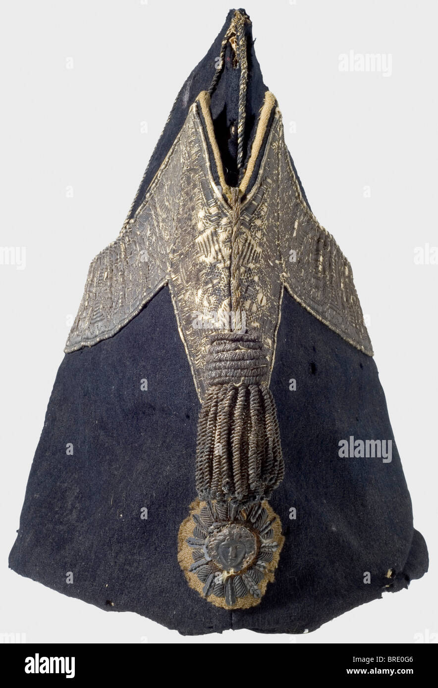 A garrison cap for enlisted men of the Gardes de Corps du Roi, as worn after 1814 Cap of dark blue cloth with silver braid lace, an attached spun silver tassel, and an embroidered emblem bearing the Medusa head. The interior lined with leather, and bearing an old 'Collection André Thélot' label, with the hand-written description, 'Bonnet de Police des Gardes du Corps Compagnie de Luxembourg Maison du Roi 1815'. The cloth shows insect damage in places. The braid is rubbed and darkened. The leather lining shows marks of wear. Height 22 cm. Interesting example of , Stock Photo