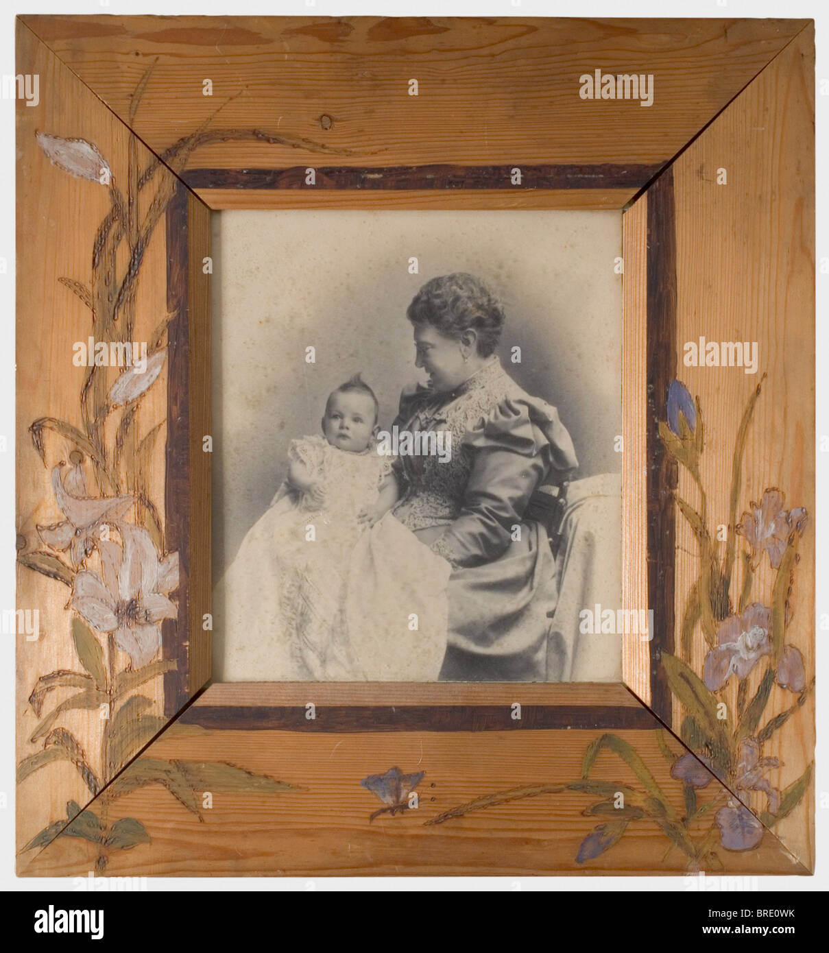 A studio photograph, with her daughter Elsa or Olga 1876/77 Large format photograph, presumably at a baptism. Dimensions 28 x 24.5 cm. The wooden frame with painted floral designs was presumably made by Vera herself. The damaged backing has the inventory label, 'H.V.v.W. G.v.R. Privat Eigentum No. 1357' for the Duchess Vera of Württemberg, Grand Duchess of Russia, and a label for the 'Royal Court Art Dealer Louis Rath Stuttgart'. Dimensions 52 x 48 cm. Provenance: Grand Duchess Vera Konstantinovna Romanova (1854 - 1912). historic, historical, people, 19th centu, Stock Photo