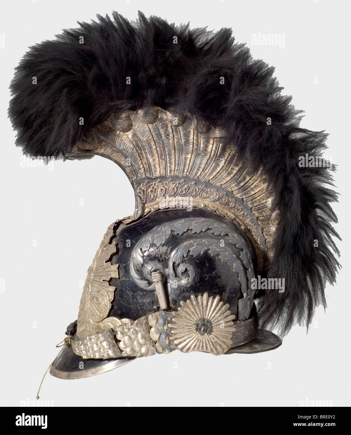 A model 1814 helmet for enlisted men, of the Gardes de Corps du Roi A lacquered leather skull with silver-plated mountings. Tall comb, also silver-plated and bearing fine relief and a black fur crest. Metal chinscales on rosettes with Medusa heads. Feather plume missing. Leather sweatband with silk lining. An illegible owner's name inside the front peak. Silver-plated pieces tarnished. Comb lightly indented on the left side, the leather backing of the chinstrap is torn, and the velvet lining is badly worn. The interior fittings display marks of wear and age. He, Stock Photo