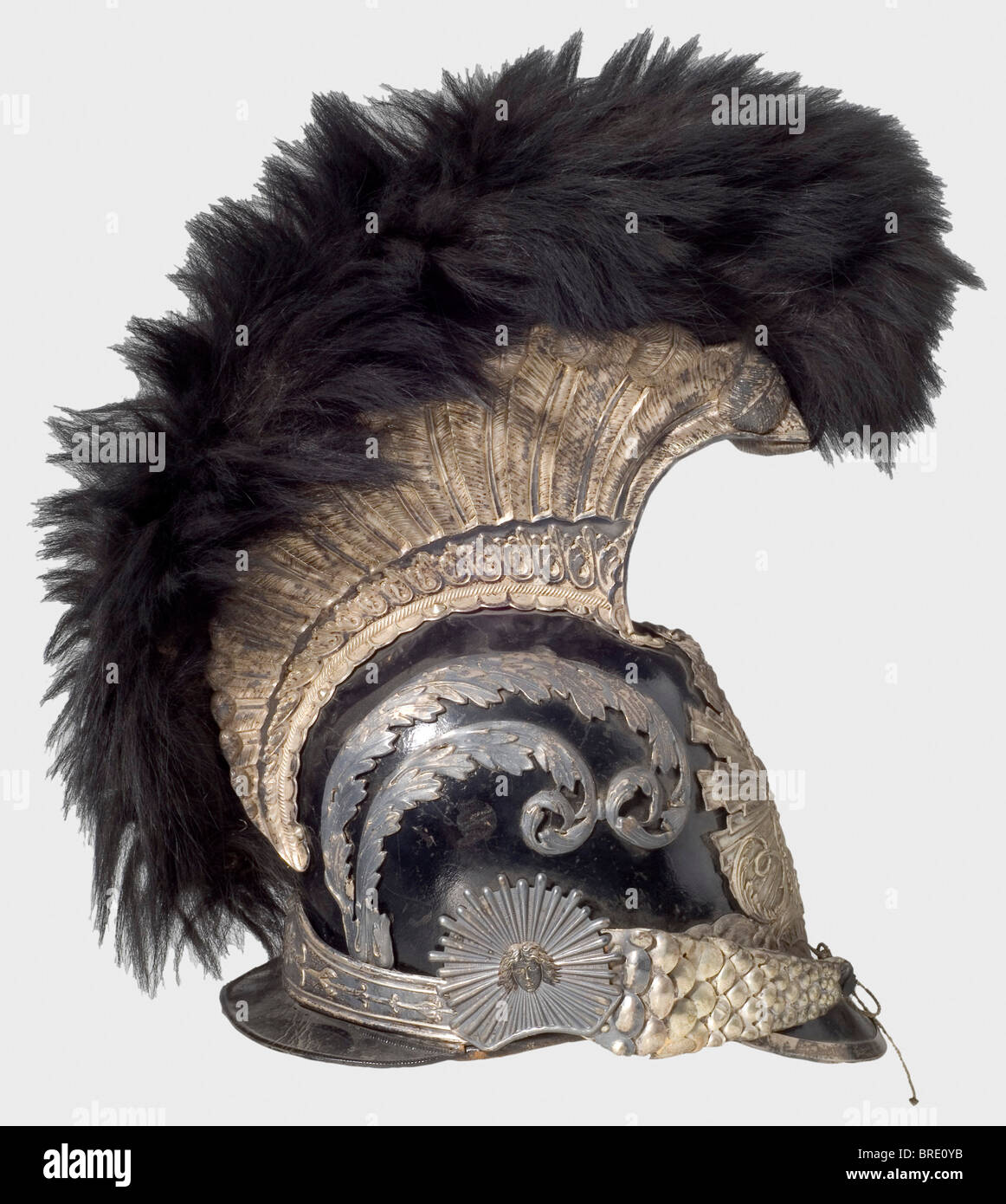 A model 1814 helmet for enlisted men, of the Gardes de Corps du Roi A lacquered leather skull with silver-plated mountings. Tall comb, also silver-plated and bearing fine relief and a black fur crest. Metal chinscales on rosettes with Medusa heads. Feather plume missing. Leather sweatband with silk lining. An illegible owner's name inside the front peak. Silver-plated pieces tarnished. Comb lightly indented on the left side, the leather backing of the chinstrap is torn, and the velvet lining is badly worn. The interior fittings display marks of wear and age. He, Stock Photo