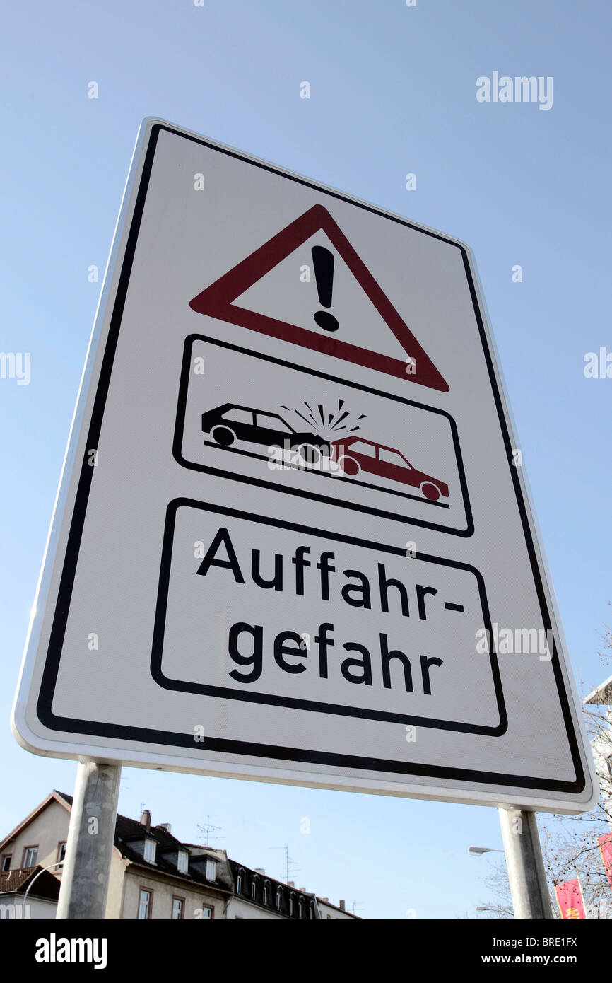 Warning sign indicating danger of rear end collisions at the entrance to a road Stock Photo