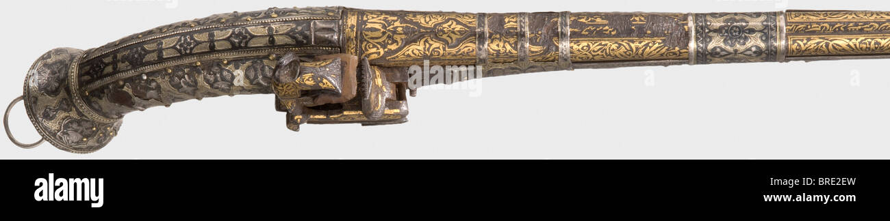 A silver-mounted Caucasian miquelet-lock pistol, dated 1824 Round Persian barrel with a smooth bore in 13 mm calibre. The entire top surface is inlaid with fine gold vine designs. The date '1240' (= 1824) on the barrel rib, in front of a long Arabic inscription. Isolated deep scars on the top. Gold-inlaid miquelet lock, button trigger. Narrow full stock. The wood is entirely covered with silver plate richly decorated with niello. The silver cover is damaged in places. Three broad barrel bands of niello silver. Length 52 cm. historic, historical, 19th century, O, Stock Photo