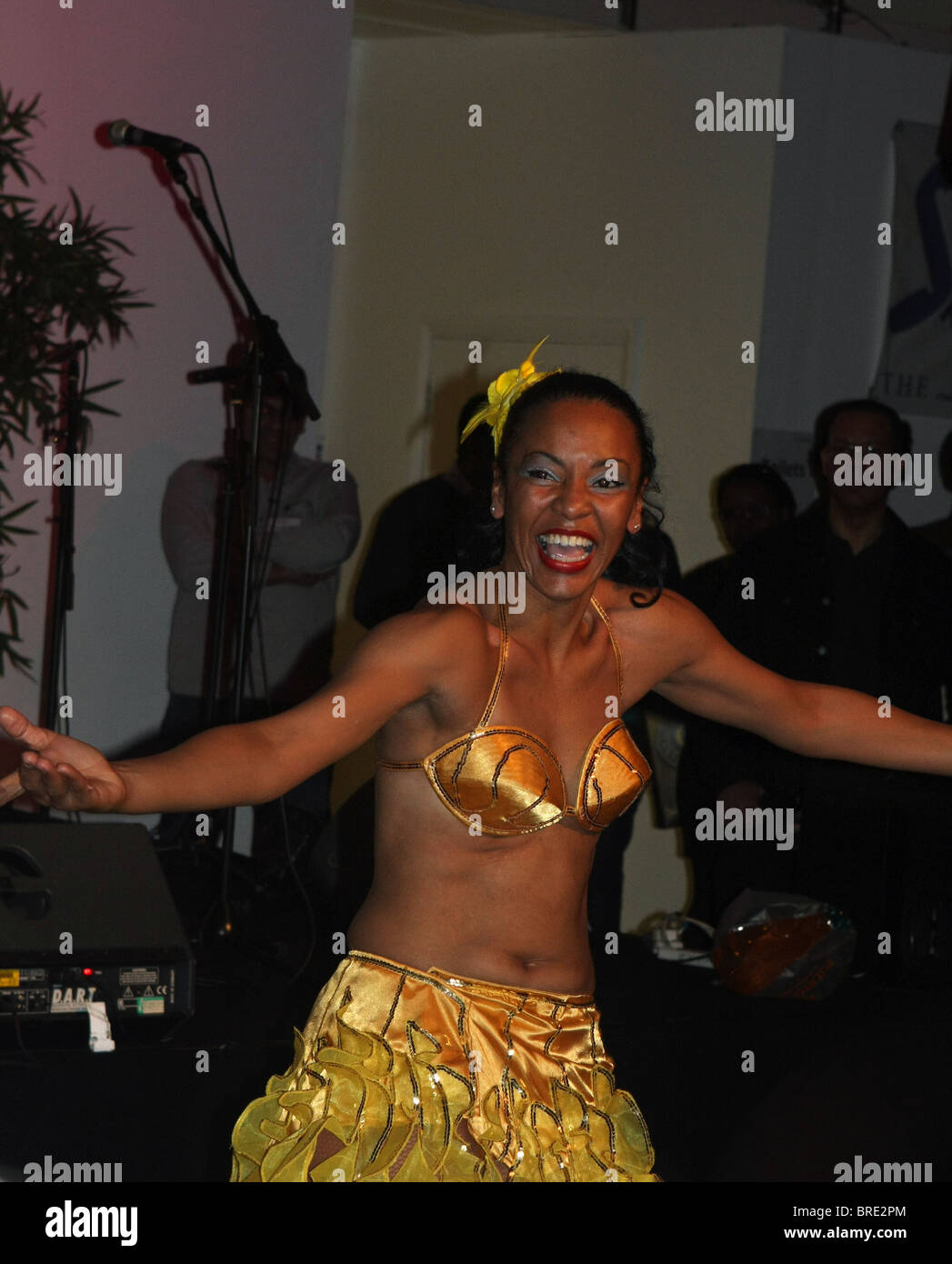A girl in festival costume giving a lesson in Cuban dancing at a Rum and Rhythm festival at Vinopolis, London Bridge, London Stock Photo