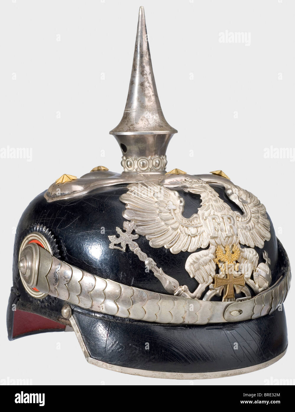 A model 1871/97 Prussian helmet, for a senior military official of the reserve Leather skull, angular front peak, cloverleaf mounting, line eagle without the Fatherland scroll and a superimposed small golden eagle and reserve cross, officer's trim and cockades, and convex metal chinscales. The mountings are silver-plated. Beige-coloured ribbed silk lining. Rare. historic, historical, 19th century, Prussian, Prussia, German, Germany, militaria, military, object, objects, stills, clipping, clippings, cut out, cut-out, cut-outs, helmet, helmets, headpiece, headpie, Stock Photo