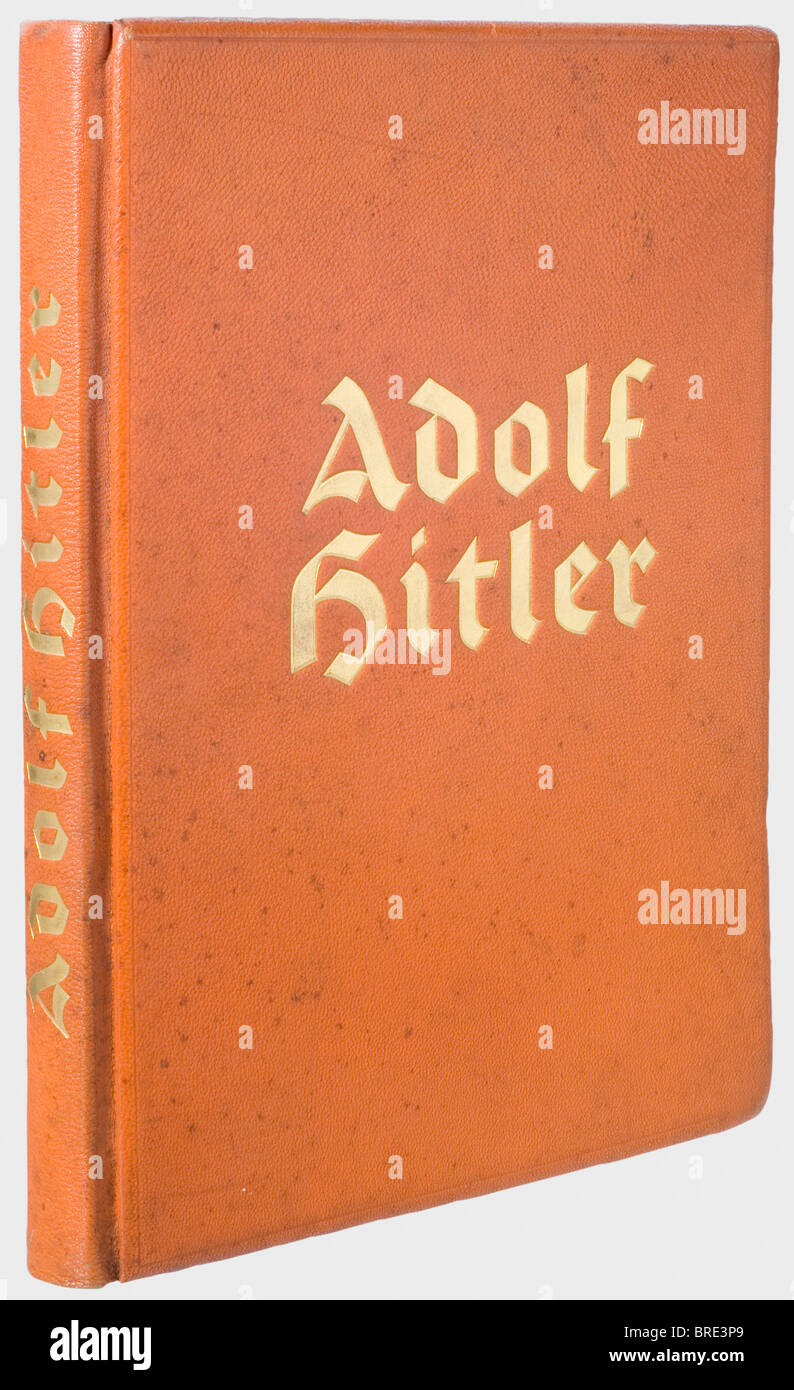 Adolf Hitler, a personal copy of the illustrated book 'Adolf Hitler' 'Adolf Hitler - Bilder aus dem Leben des Führers', ed. Cigarette/Picture Service Altona/Bahrenfeld 1936. The last page with the inscription 'Three hundred copies of the 'Adolf Hitler' book published by F.A. Brockhaus, Leipzig, were bound in real saffian leather. This copy bears the number '1'' (transl.). On the inside of the cover the ex libris 'Adolf Hitler', on the flyleaf the handwritten ink signature 'Martin Bormann Obersalzberg 26.7.36'. Incl. dust jacket. De luxe edition in gold-embossed, Stock Photo