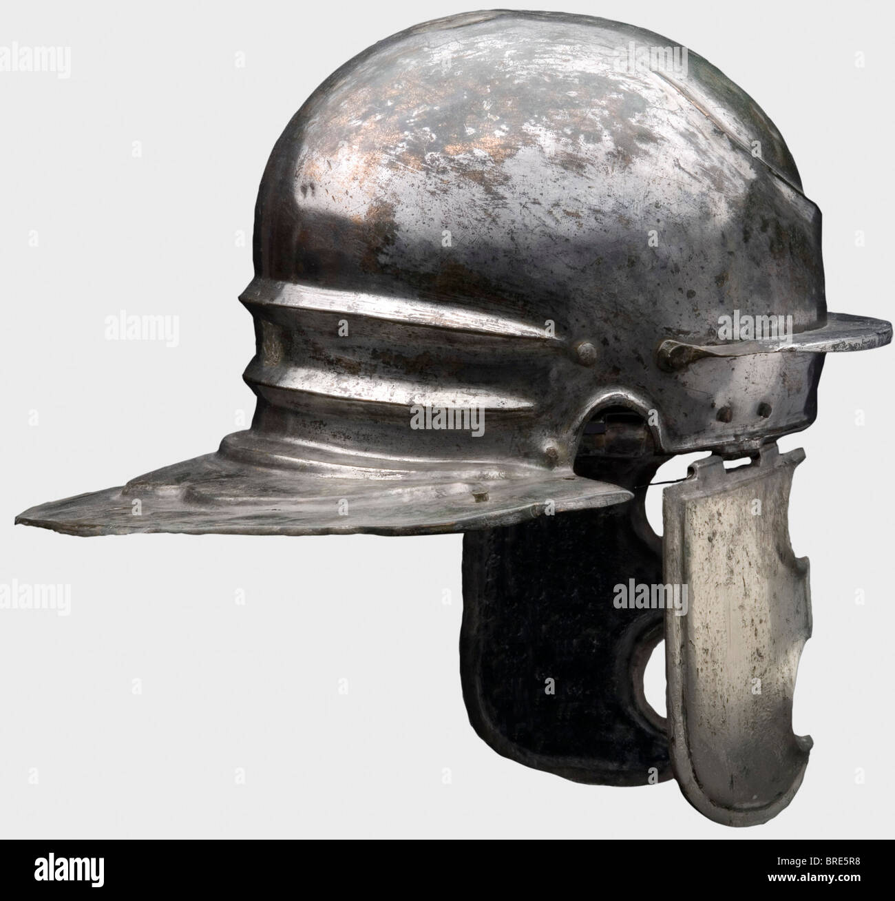 A Roman helmet of the Weisenau/Nijmegen type, 1st century B.C. to 1st  century A.D. Brass or bronze with distinct hammer marks on the inside and  tinned exterior. Widely flaring, contoured neck-guard with