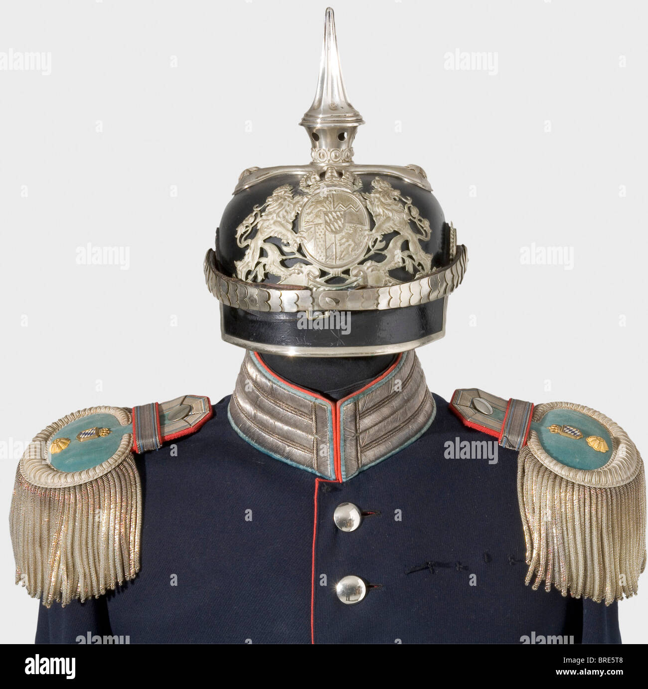 A helmet, uniform and insignia, from the estate of Senior Judge Advocate Gerstner A model 1886 helmet, leather skull with an angular front peak, clover leaf top plate, fluted spike, convex, silver-plated metal chinscales, officer's cockades, silver-plated emblem, and light blue silk lining with remnants of the owner's name in gold. It comes with the protective case. A dark blue uniform coat, silver buttons, poppy red piping and silver embroidery on the light blue velvet collar and cuffs. Epaulette loops cut off, but present. A pair of epaulettes for a Senior Ju, Stock Photo
